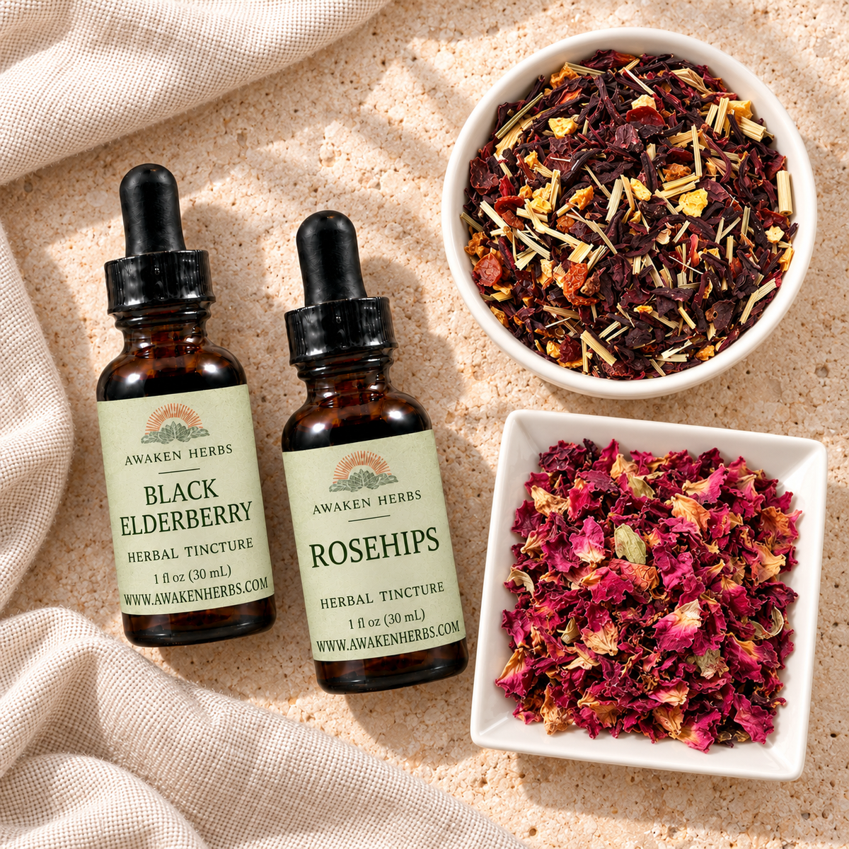Berry & Blossom Bundle: overhead view of two tinctures, Hibiscus Heaven Tea and Pink Rose Petals on pale stone.