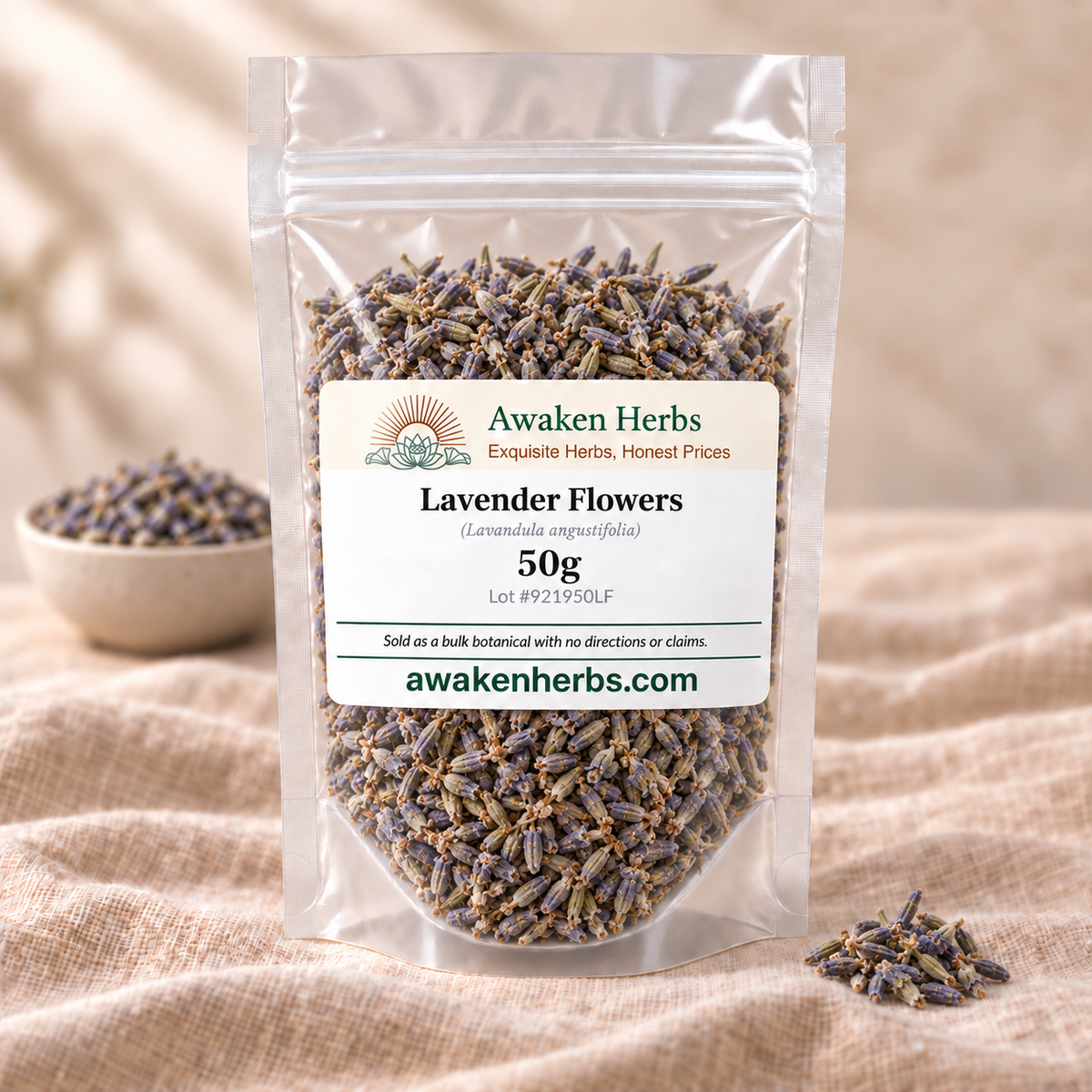 Awaken Herbs Lavender Flowers 50g clear pouch with an ivory label, beside a softly blurred product bowl on beige linen.
