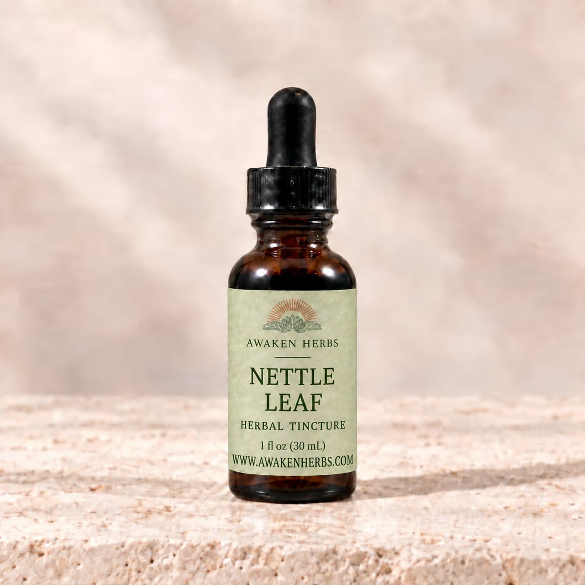 Awaken Herbs Nettle Leaf Tincture, 1 fl oz bottle on pale stone