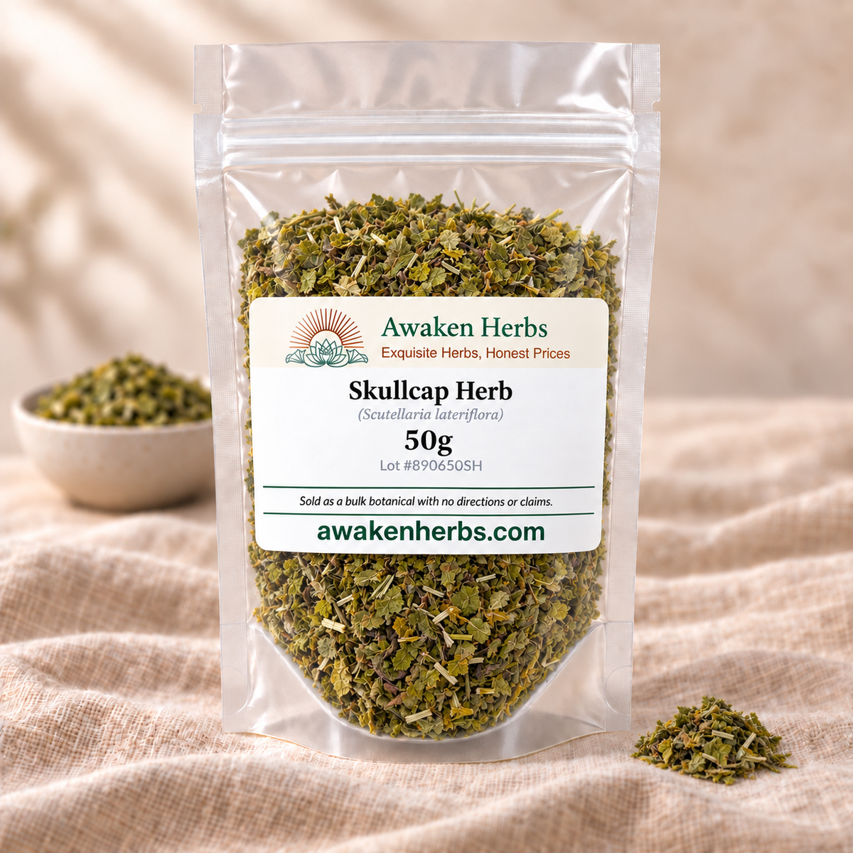 Awaken Herbs Skullcap Herb 50g in a clear stand-up pouch on beige linen, with a softly blurred bowl and one small product cluster.