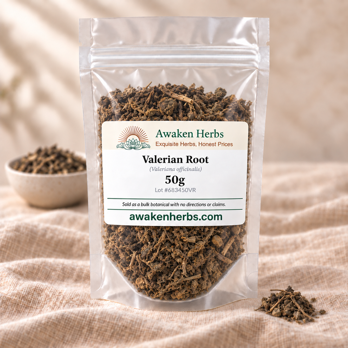 Awaken Herbs Valerian Root 50g in a clear stand-up pouch on beige linen, with a softly blurred bowl and a small matching herb cluster.